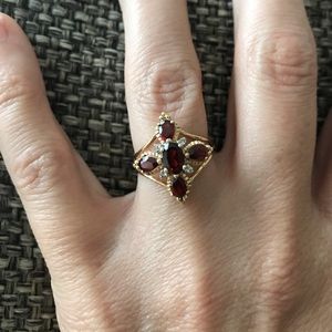 Garnet ring with diamond accents in 10k gold.